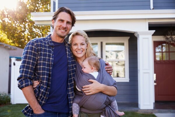 Portrait Of Family Standing Outside House