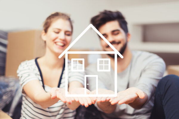 Young Couple Holding Their New Dream Home In Hands Young Couple Holding Their New Dream Home In Hands