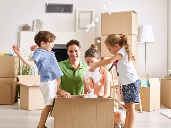 Family Unpacking Cardboard Box