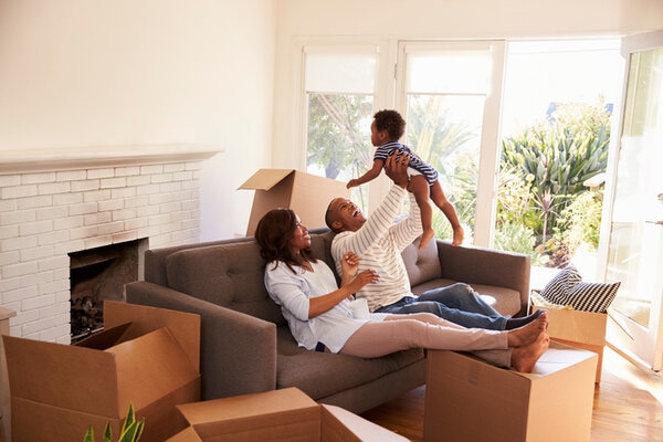 Parents Take A Break On Sofa With Son On Moving Day