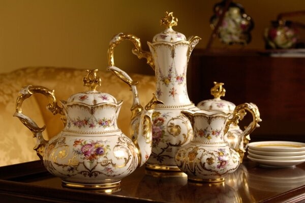 An Table With An Antique Tea And Coffee Set On Top